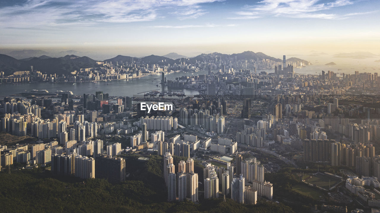 Aerial view of buildings in city against sky