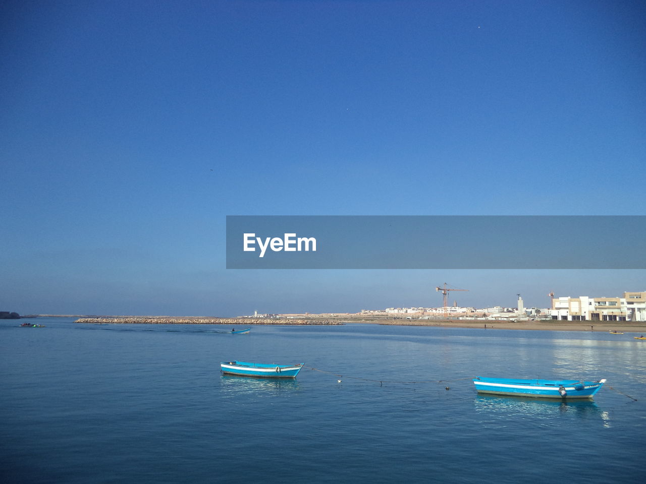 Scenic view of sea against clear blue sky