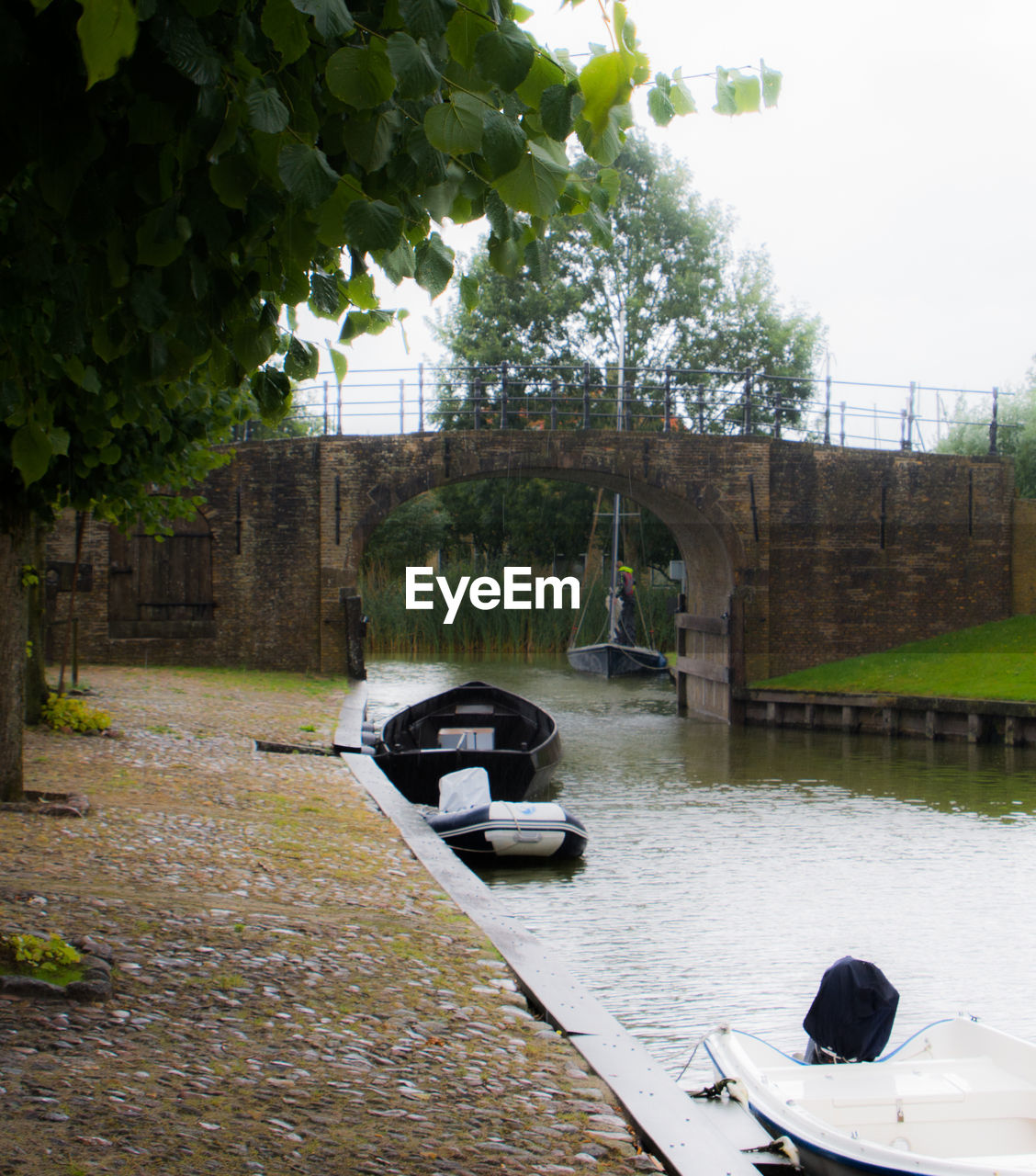 MAN UNDER BRIDGE OVER RIVER