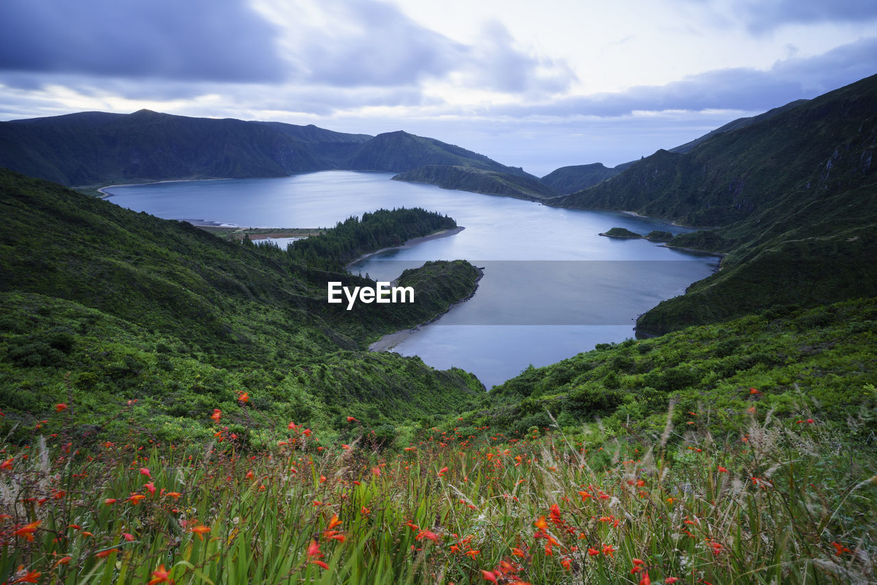 Scenic view of land and mountains against sky