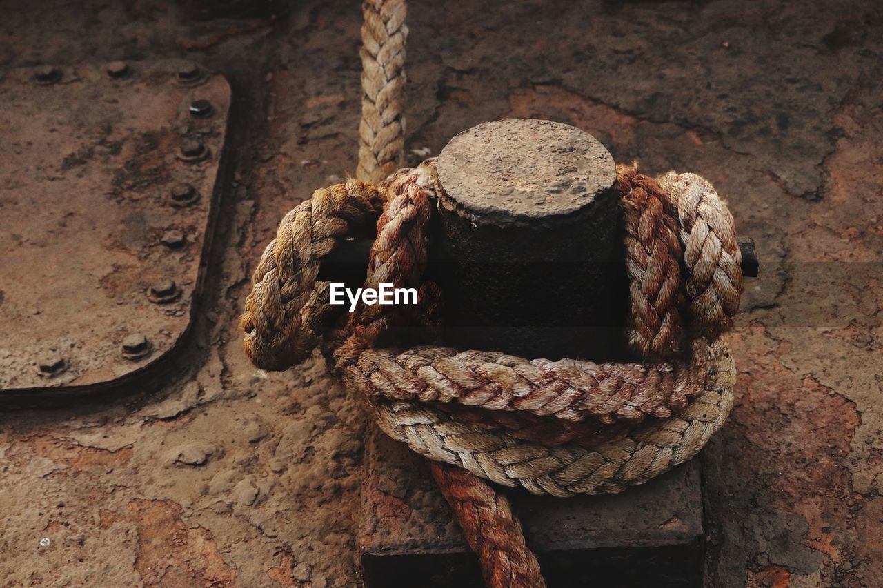 Close-up of rope tied on bollard