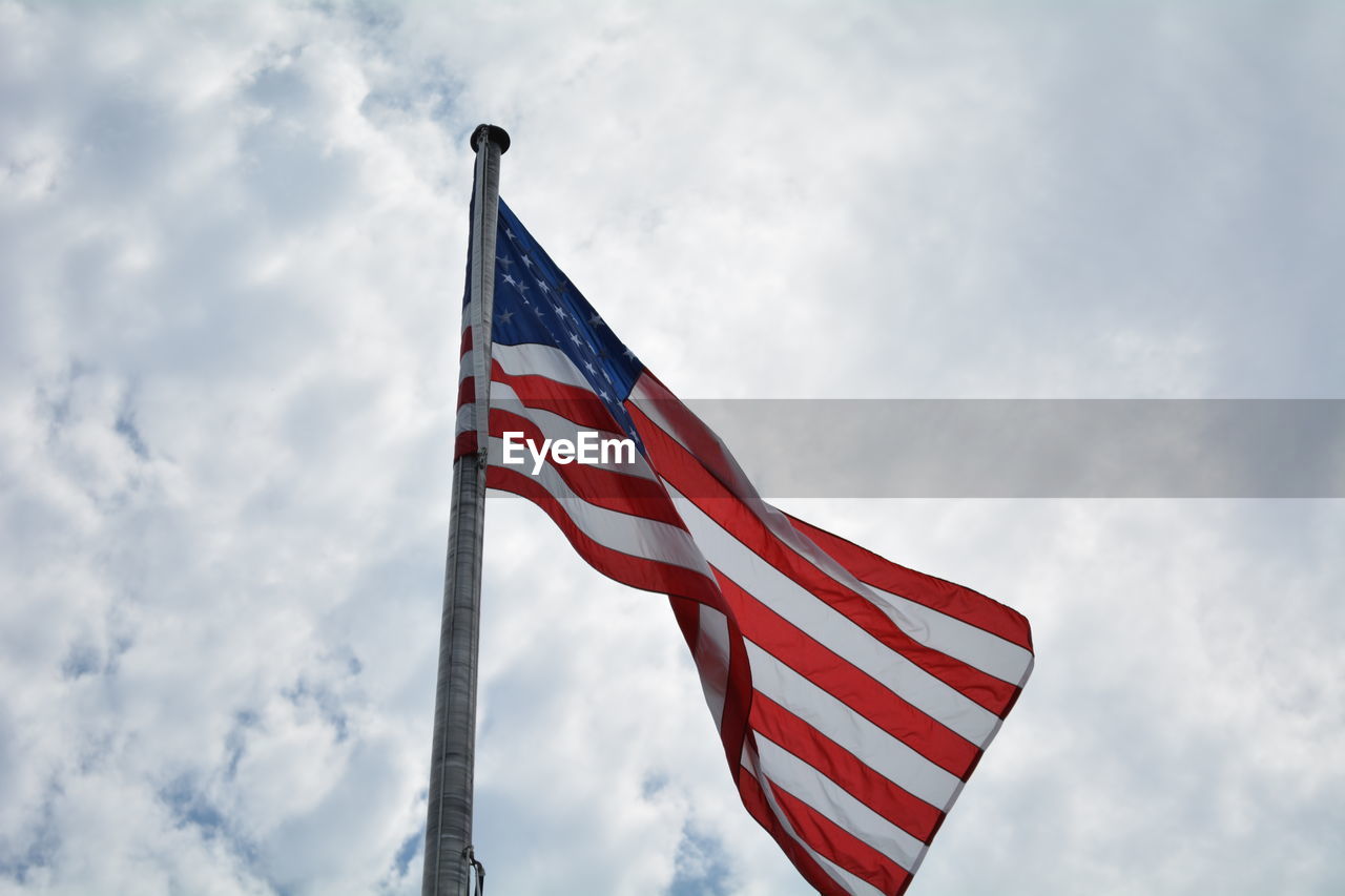 Low angle view of flag against sky