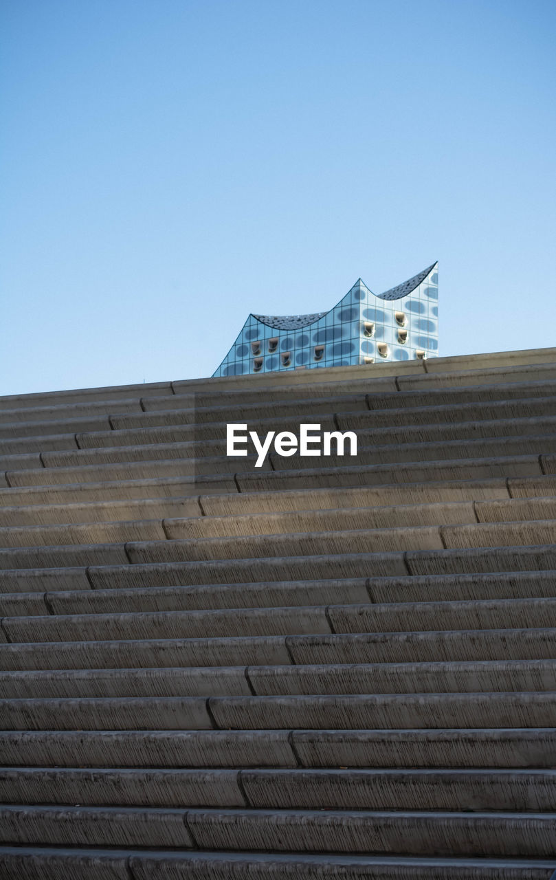 LOW ANGLE VIEW OF BUILT STRUCTURE AGAINST BLUE SKY