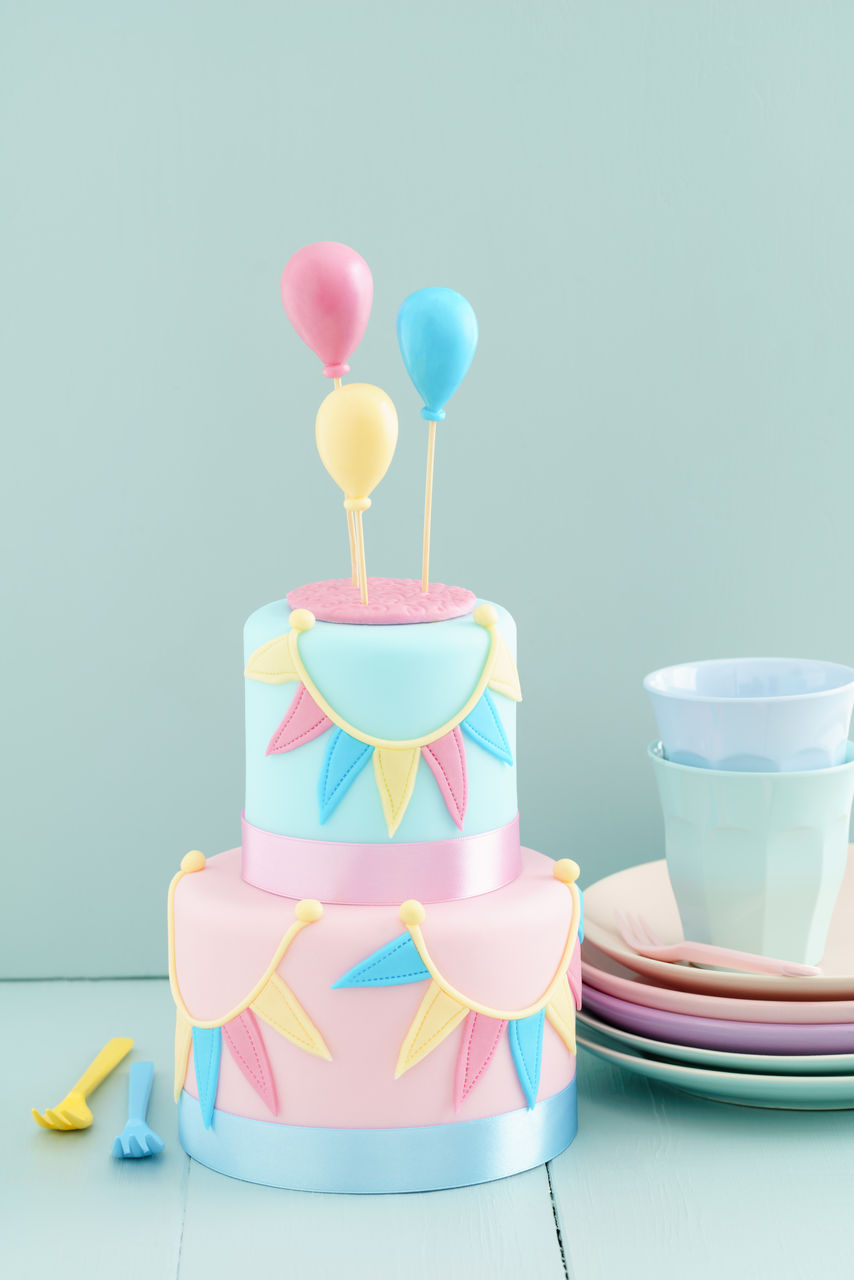 CLOSE-UP OF MULTI COLORED BALLOONS ON TABLE