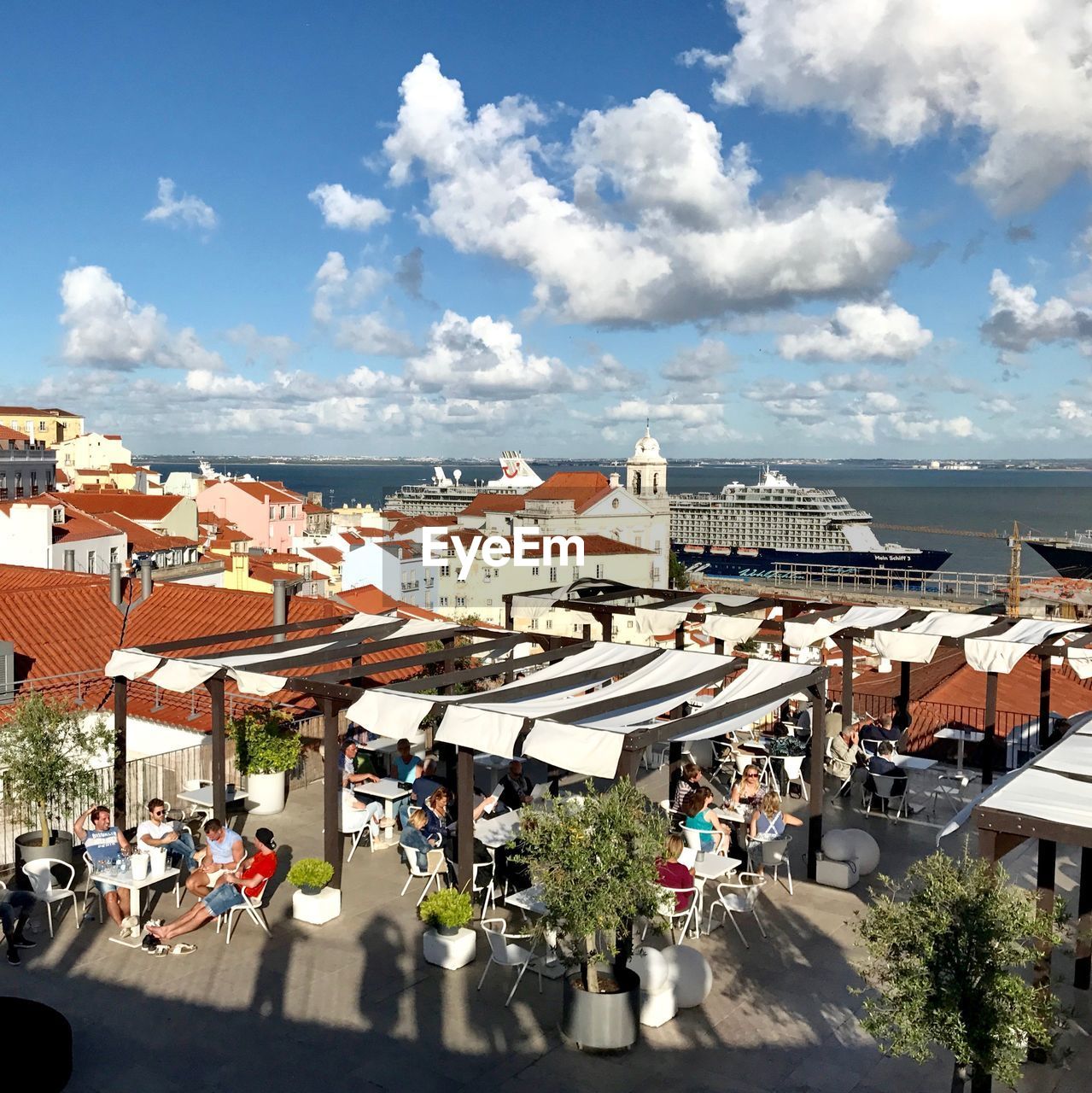 HIGH ANGLE VIEW OF PEOPLE IN CITY AGAINST SKY