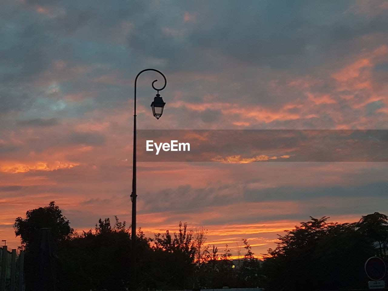 sky, sunset, cloud, dusk, street light, evening, silhouette, nature, afterglow, tree, street, no people, architecture, plant, orange color, lighting equipment, sun, outdoors, beauty in nature, horizon, red sky at morning, city, built structure, dramatic sky, tranquility