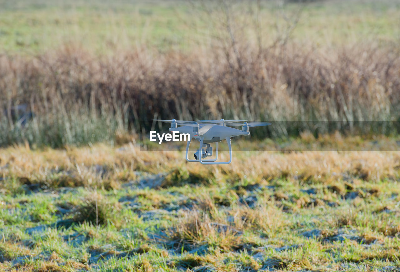 Drone flying over field