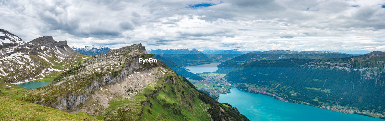 Scenic view of sea and mountains against sky