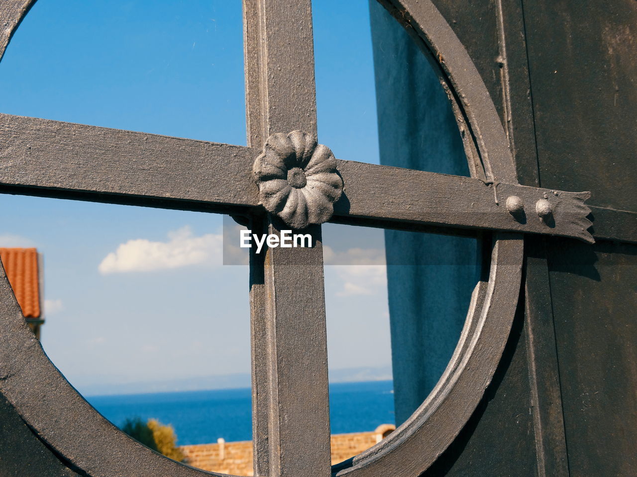 CLOSE-UP OF METAL STRUCTURE AGAINST SEA