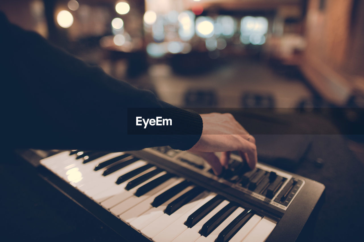 Close-up of hands playing the piano