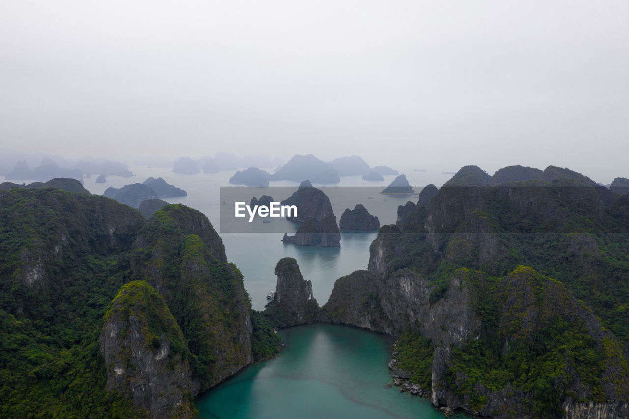 Scenic view of sea and mountains against sky