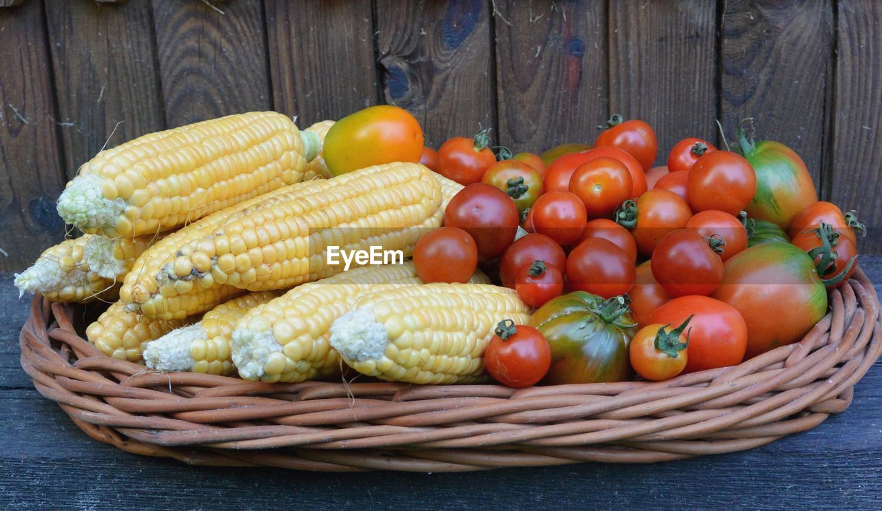 CLOSE-UP OF TOMATOES IN WICKER BASKET