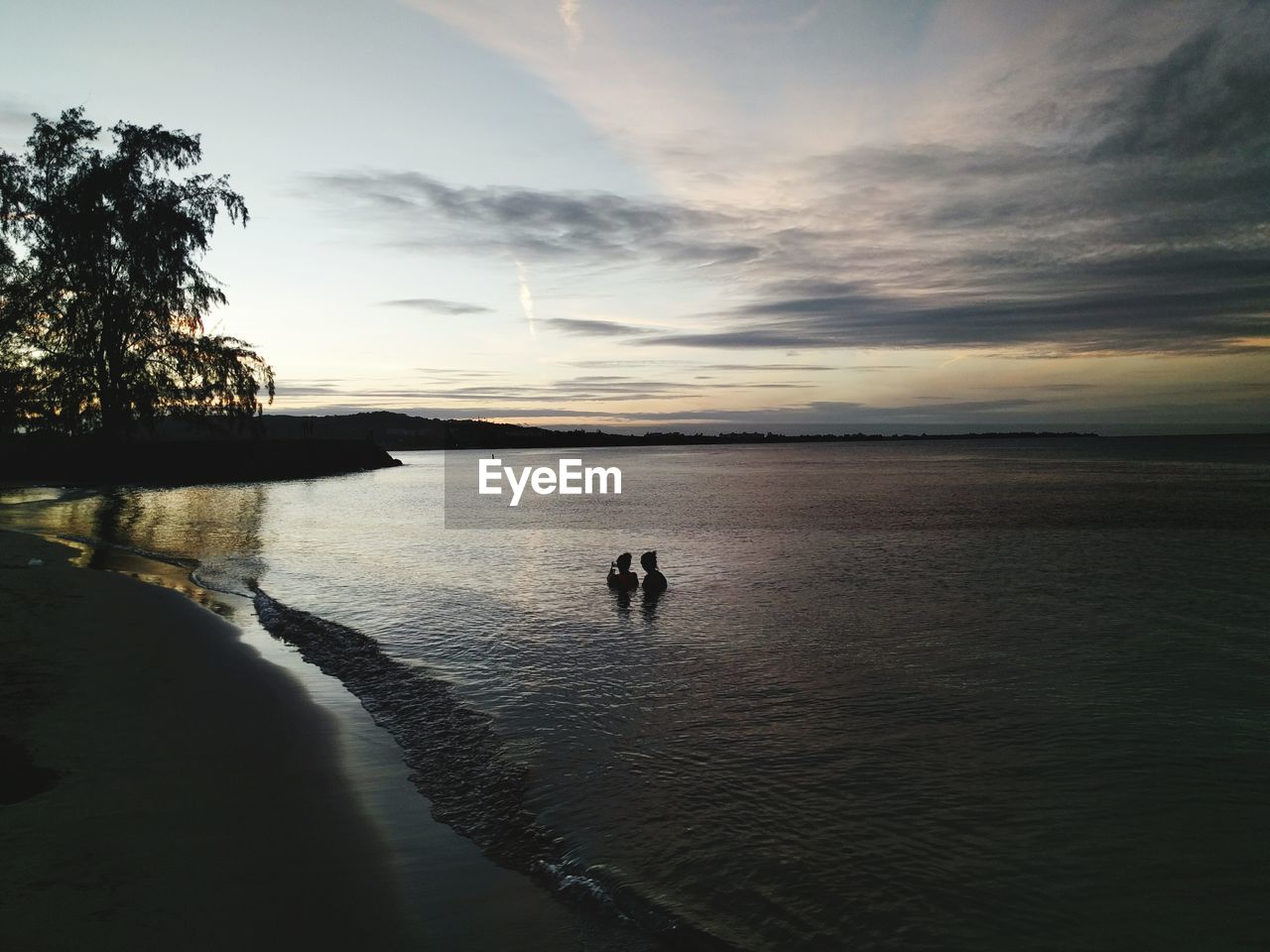 Scenic view of beach against sky during sunset