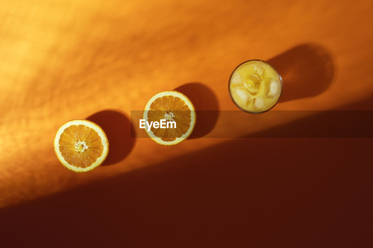 Close-up of oranges with drink on table