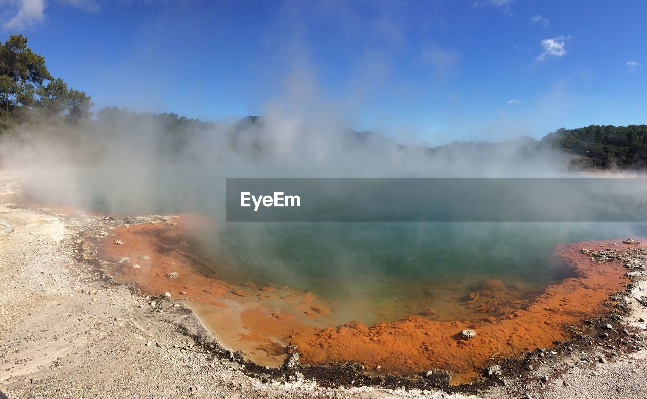 SMOKE EMITTING FROM CLOUDS OVER LANDSCAPE