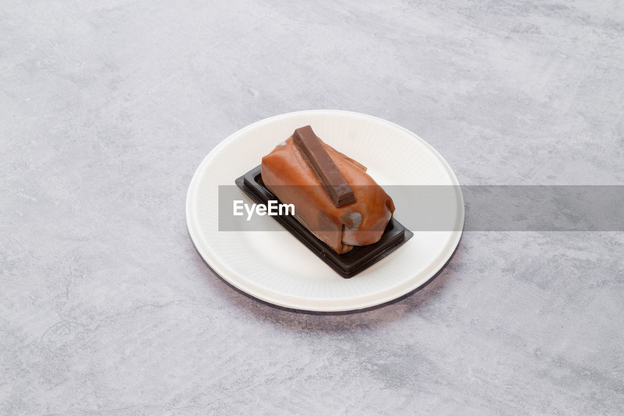 plate, food and drink, sweet food, food, sweet, dessert, high angle view, no people, baked, freshness, indoors, gray, chocolate, copy space, table, cake, frozen, studio shot, tableware, white, platter, saucer, unhealthy eating, still life