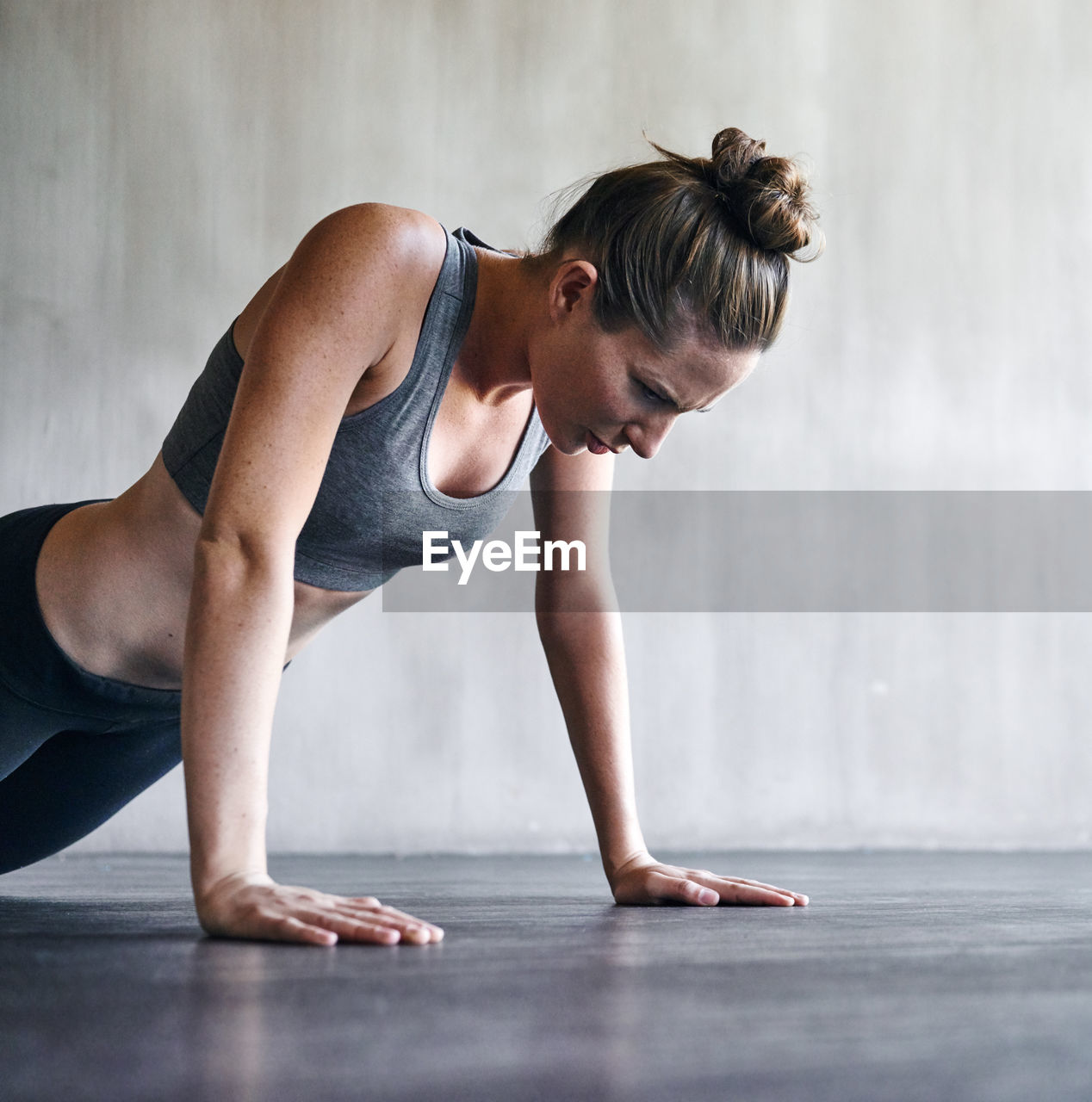 Determined woman doing push ups on floor