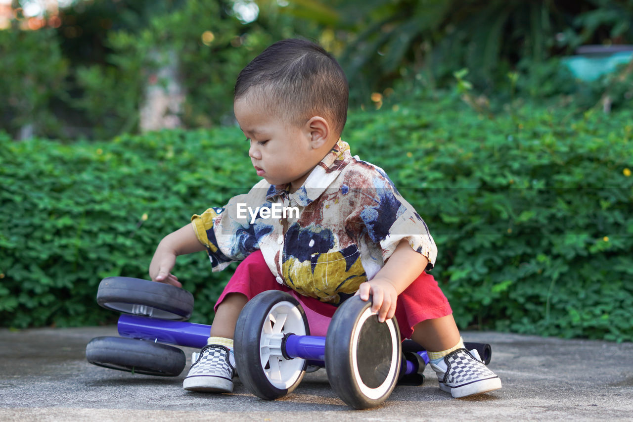 Cute boy playing toy outdoors