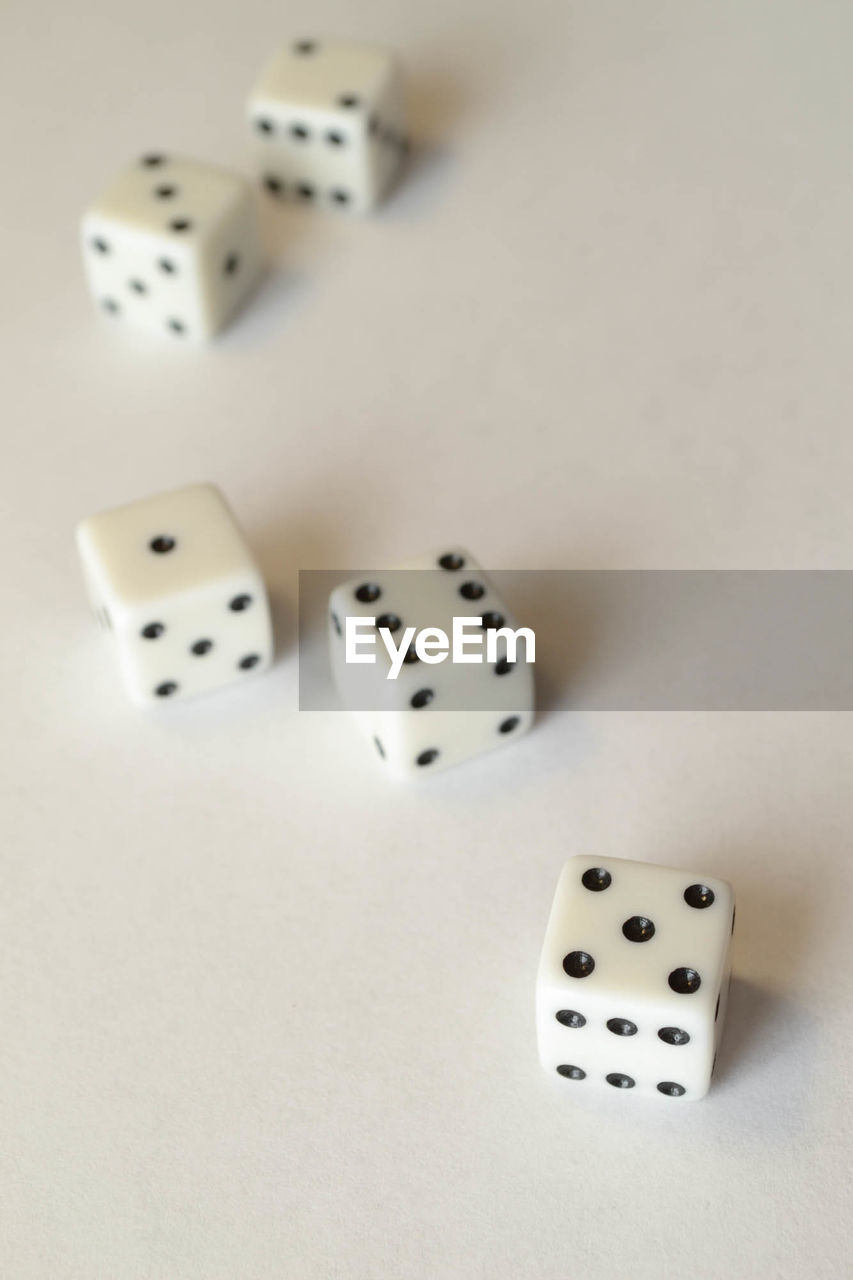 High angle view of dices on white table