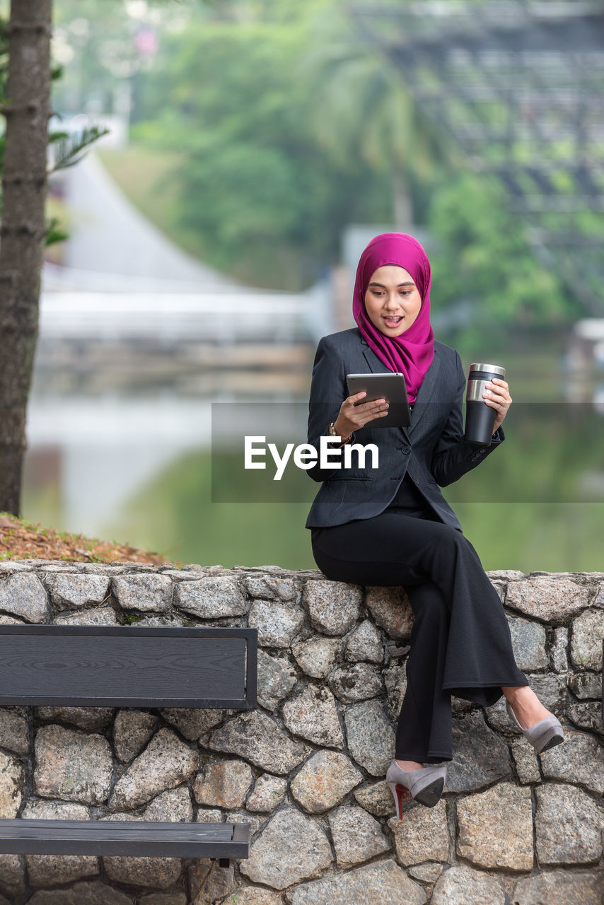 Young businesswoman wearing hijab using digital tablet