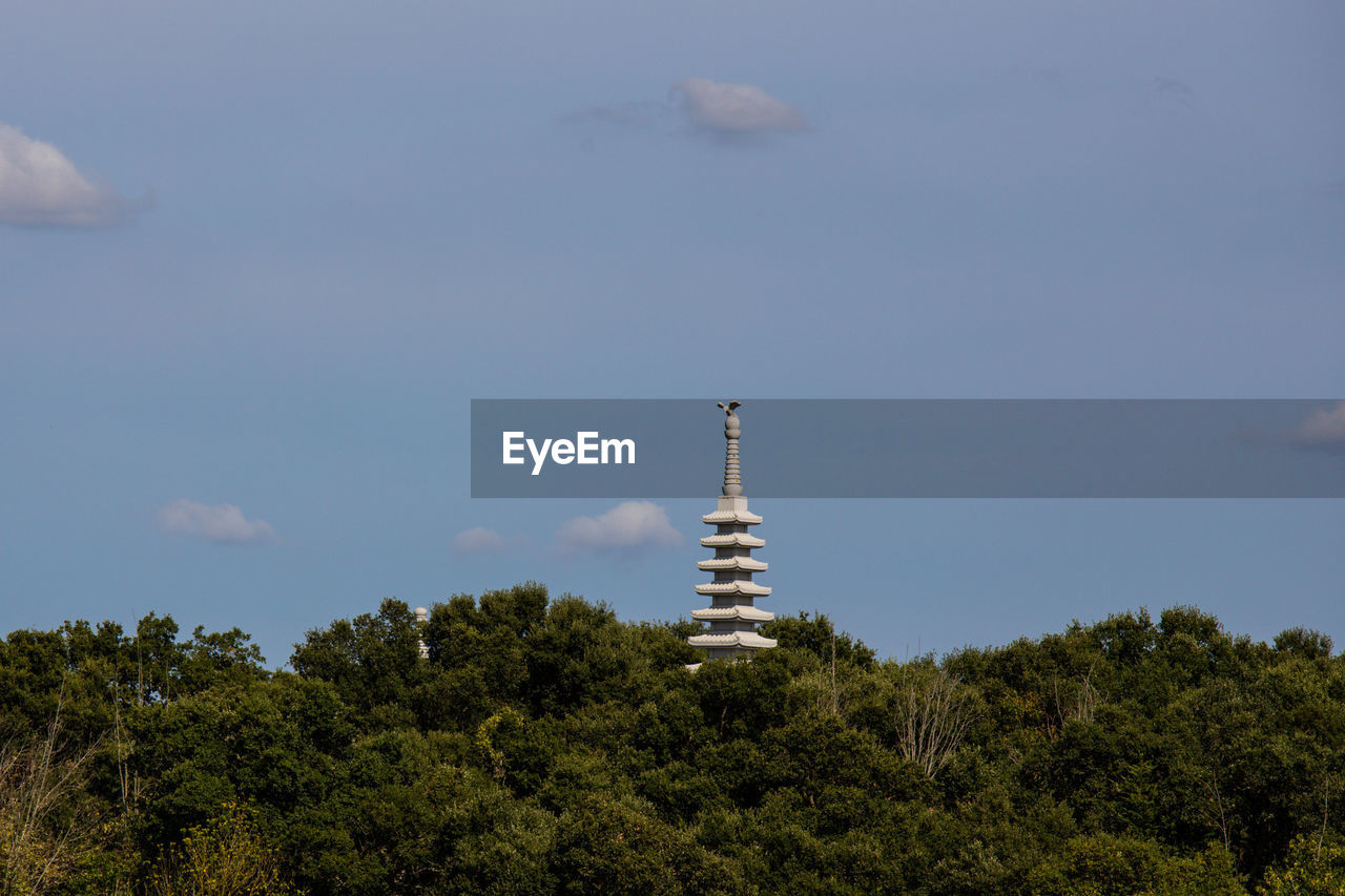 LOW ANGLE VIEW OF TOWER AND BUILDING AGAINST SKY