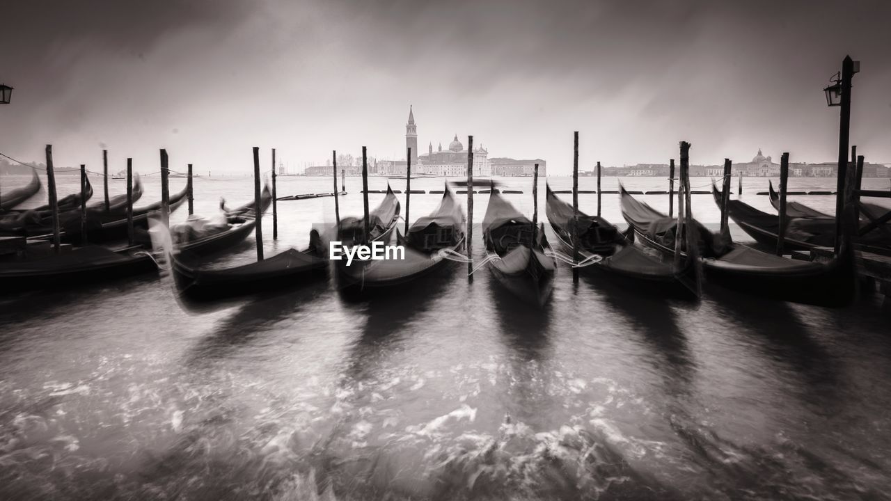 BOATS MOORED ON SEA