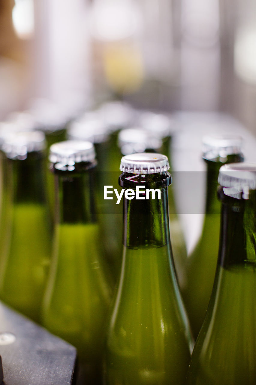 Close-up of lids on beer bottles at brewery