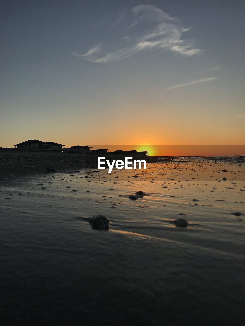 SCENIC VIEW OF BEACH DURING SUNSET