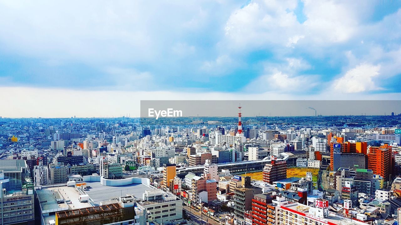 High angle view of cityscape against cloudy sky