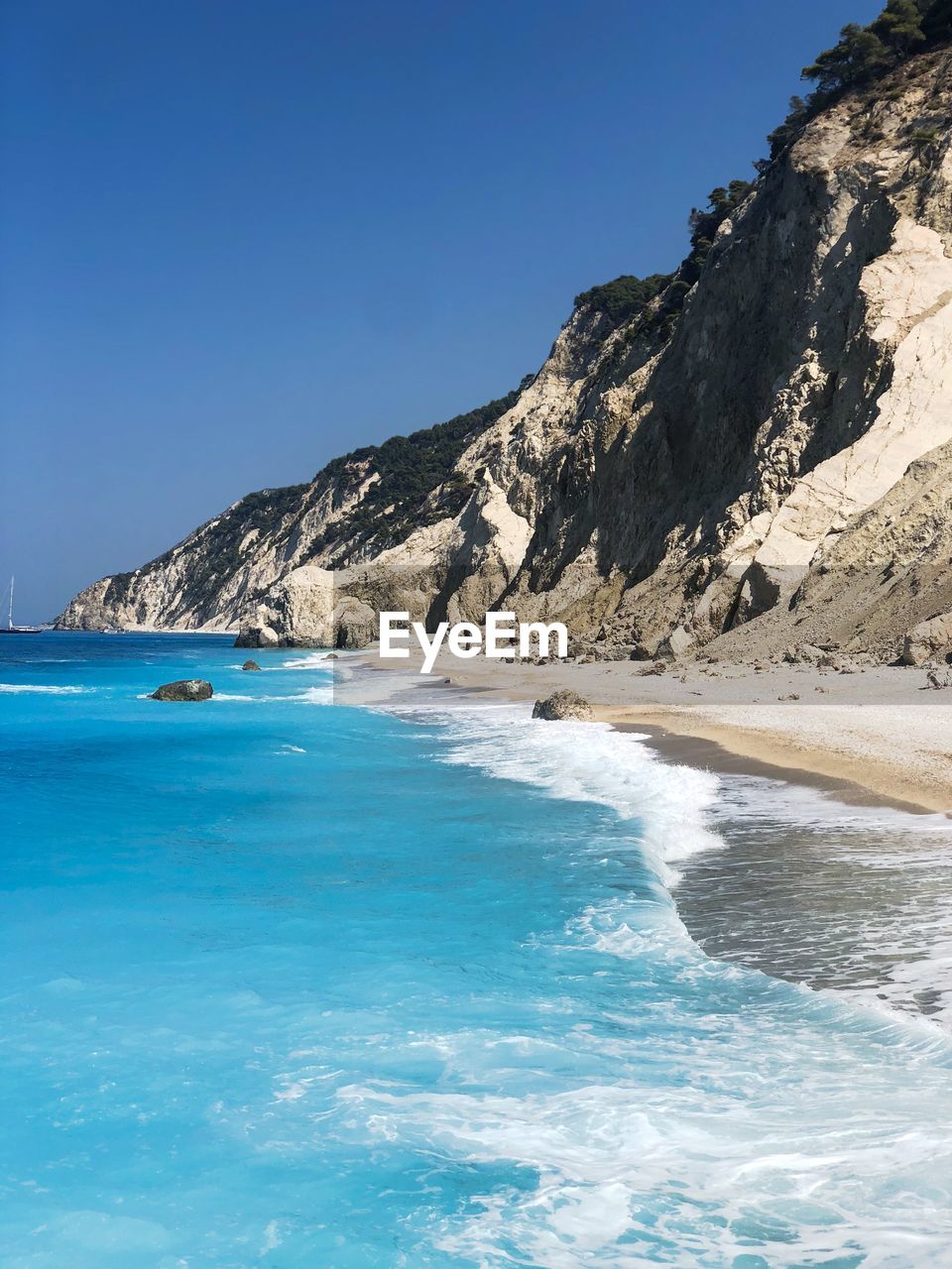 Scenic view of sea against clear blue sky