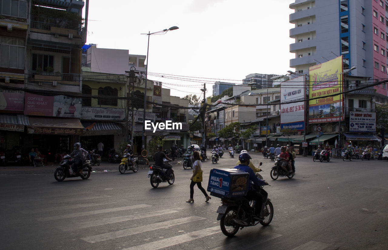 PEOPLE RIDING BICYCLE ON CITY STREET