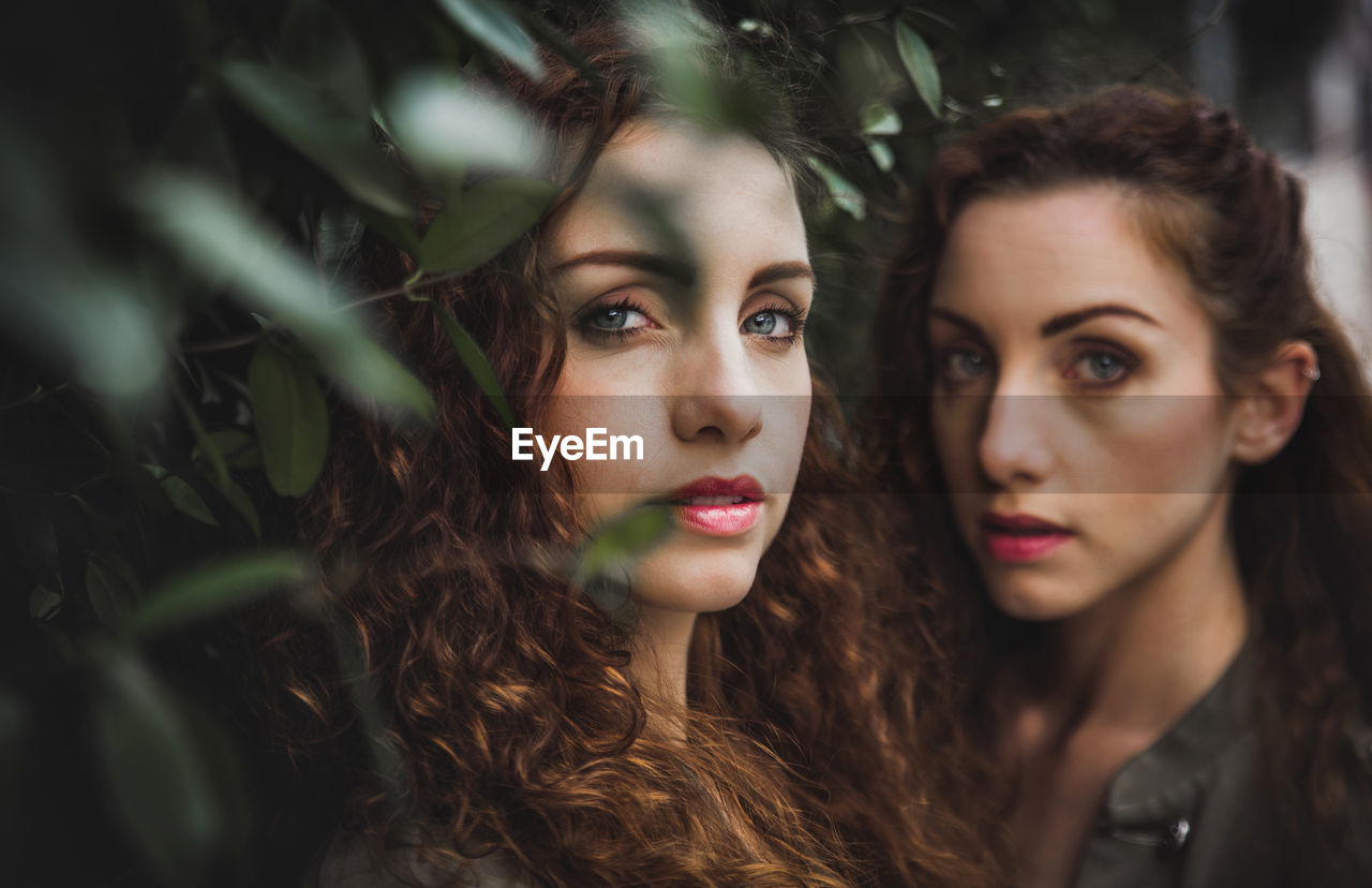 Portrait of siblings against plants