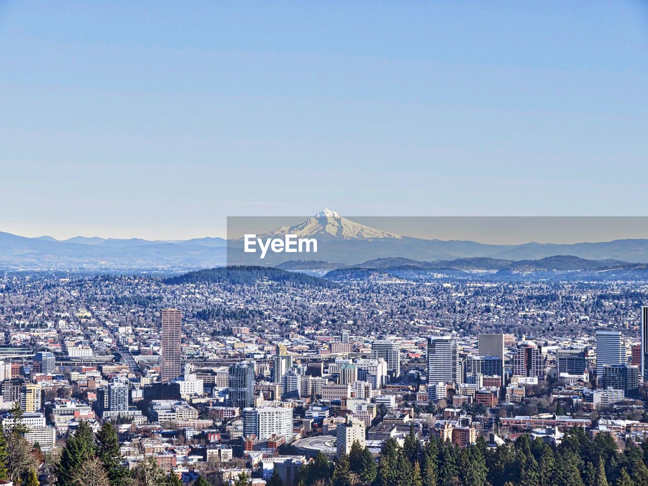 View of cityscape against blue sky