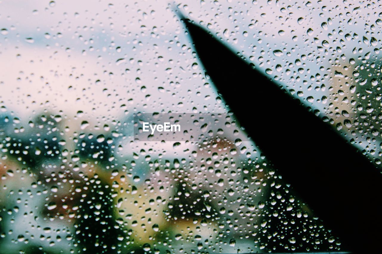 FULL FRAME SHOT OF RAINDROPS ON GLASS WINDOW