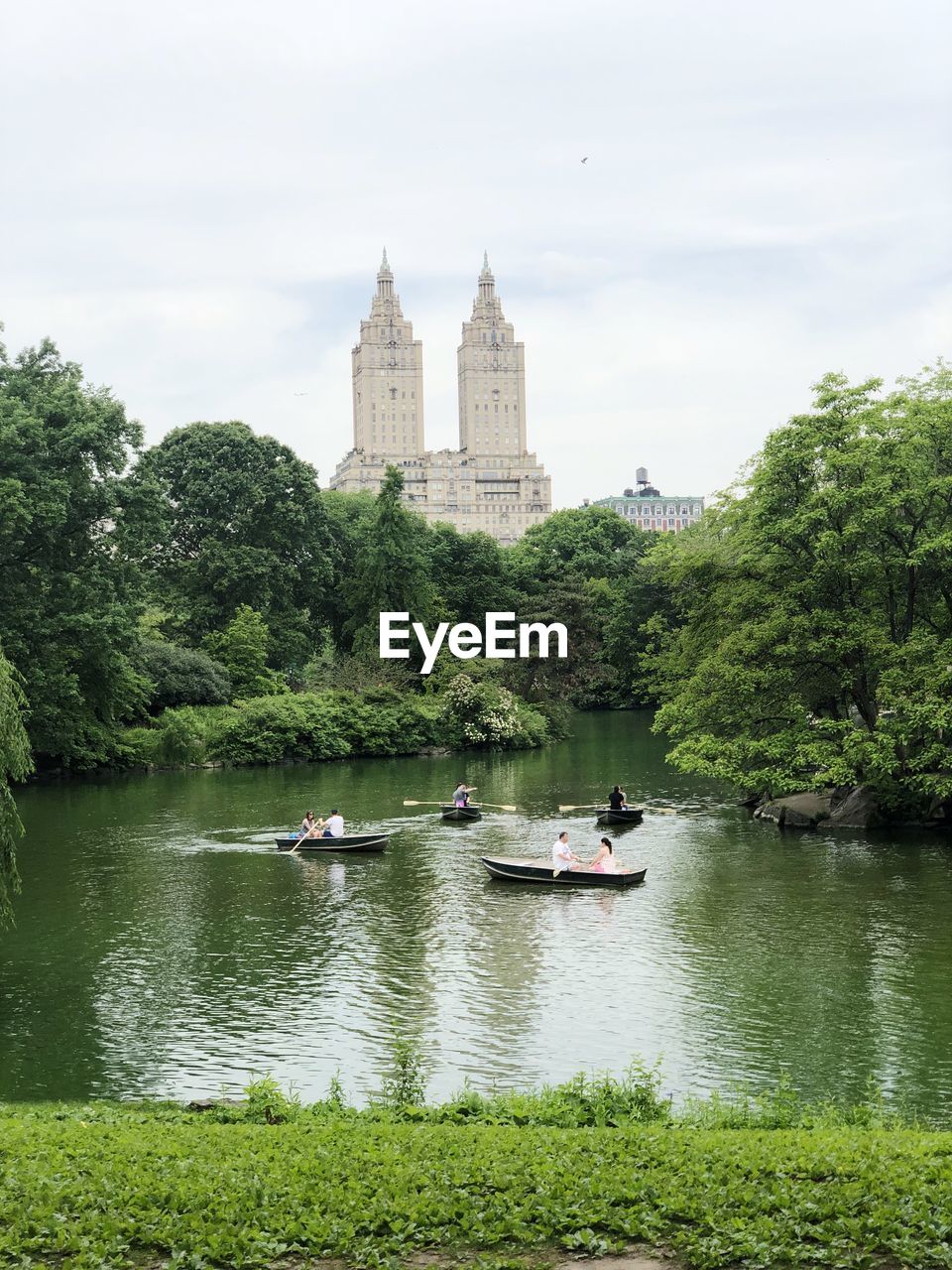 Boats in river with buildings in background