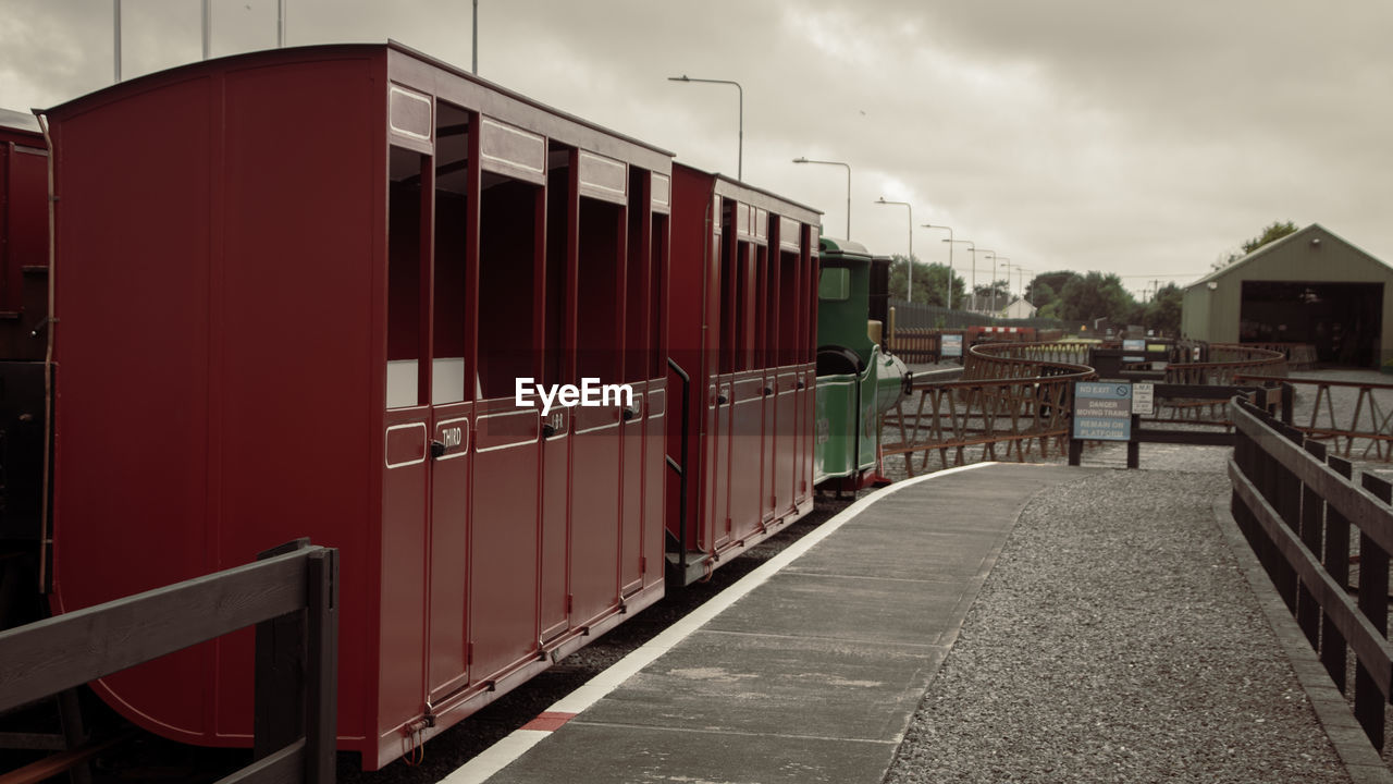 architecture, cloud, sky, transport, transportation, urban area, shipping container, built structure, nature, building exterior, rail transportation, mode of transportation, business, outdoors, city, building, train, water, freight transportation, travel, pier