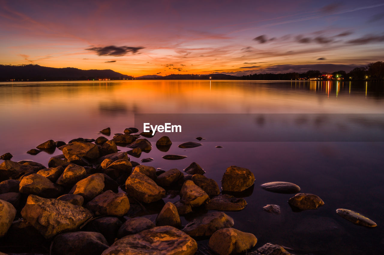 Scenic view of lake against sky during sunset