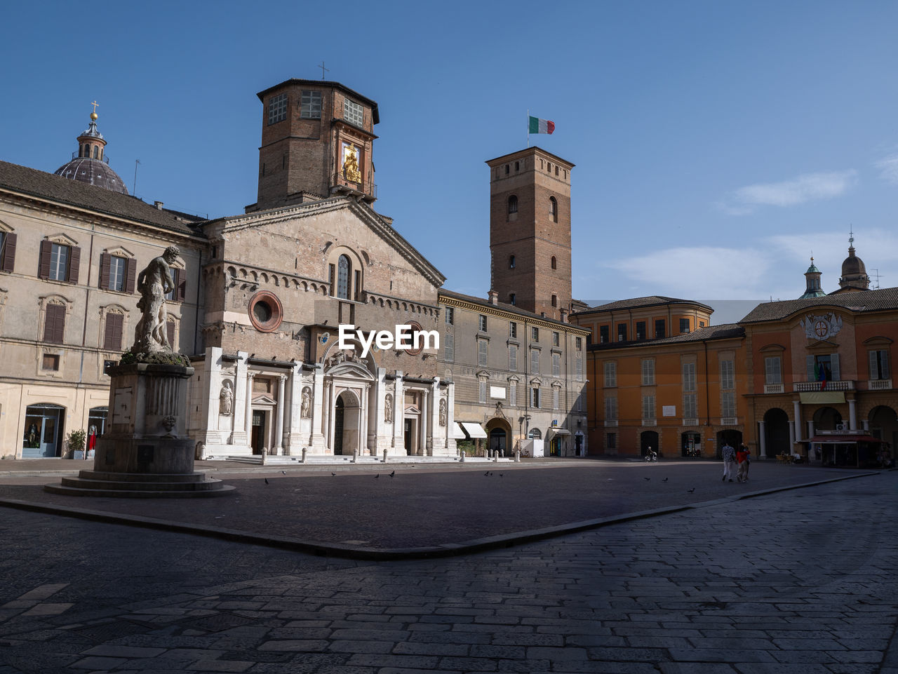 architecture, building exterior, built structure, town, city, travel destinations, sky, town square, building, landmark, history, place of worship, the past, religion, street, nature, travel, cityscape, belief, tourism, spirituality, tower, cobblestone, blue, clear sky, urban area, worship, facade, old, downtown, catholicism, outdoors, day, sunny, city street
