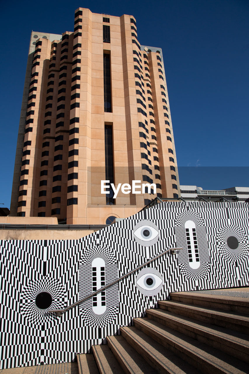 Low angle view of building against clear blue sky