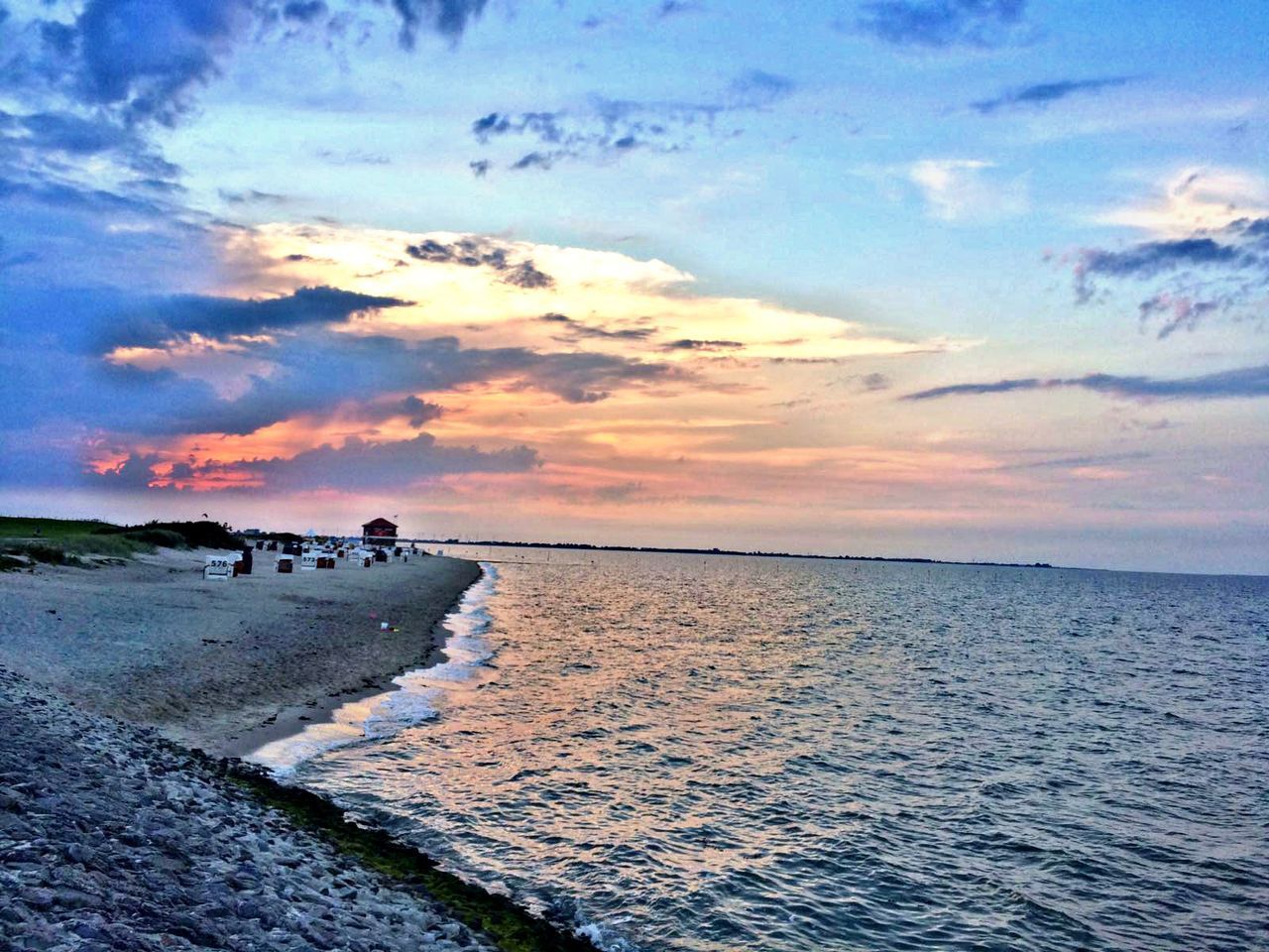 SCENIC VIEW OF CALM SEA AT SUNSET