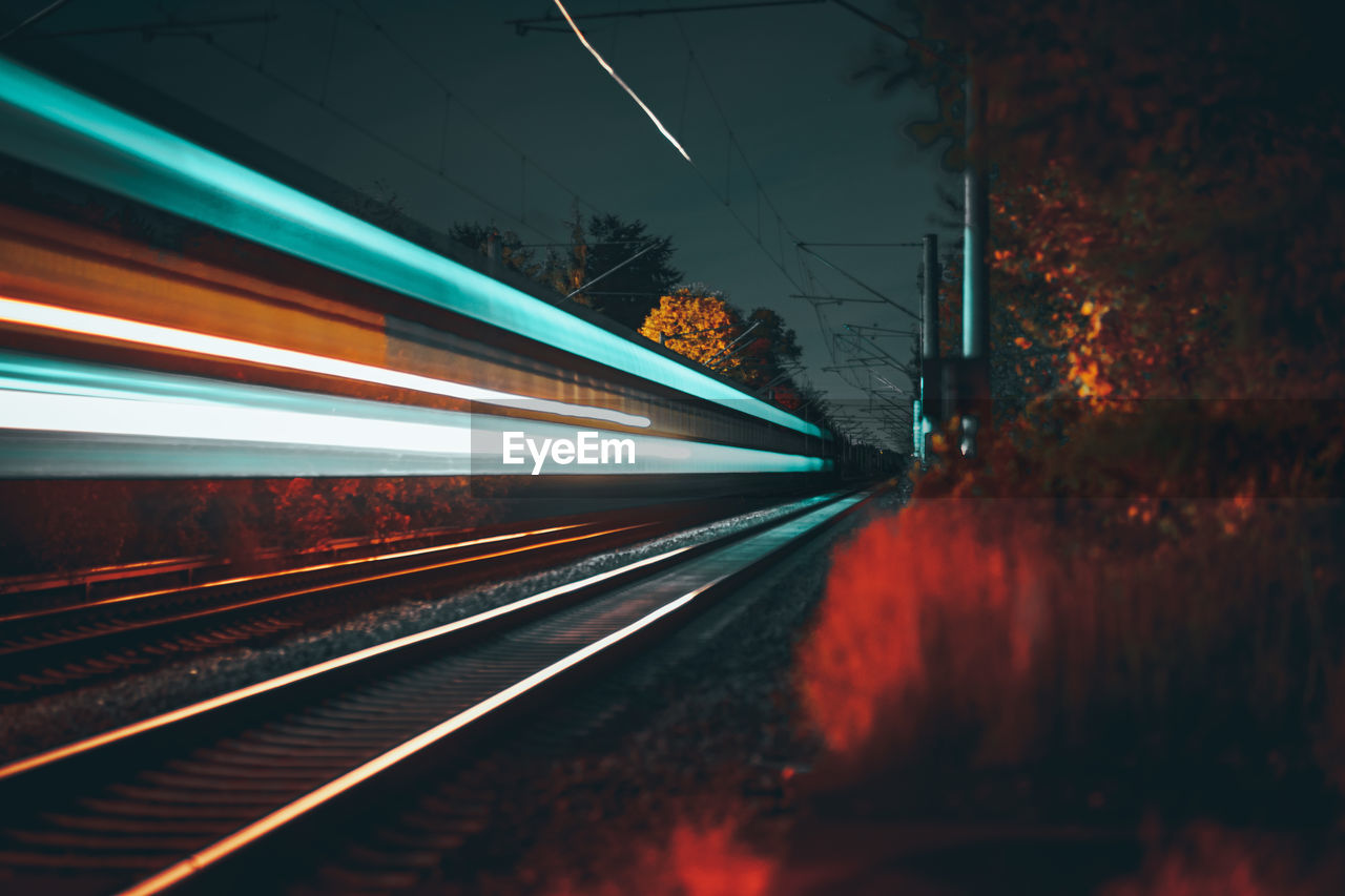 Light trails on railroad track at night