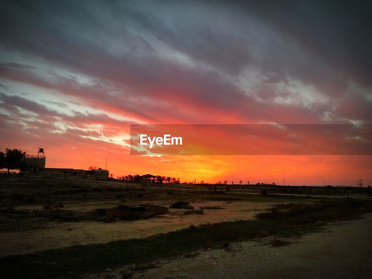 Scenic view of beach against sunset sky