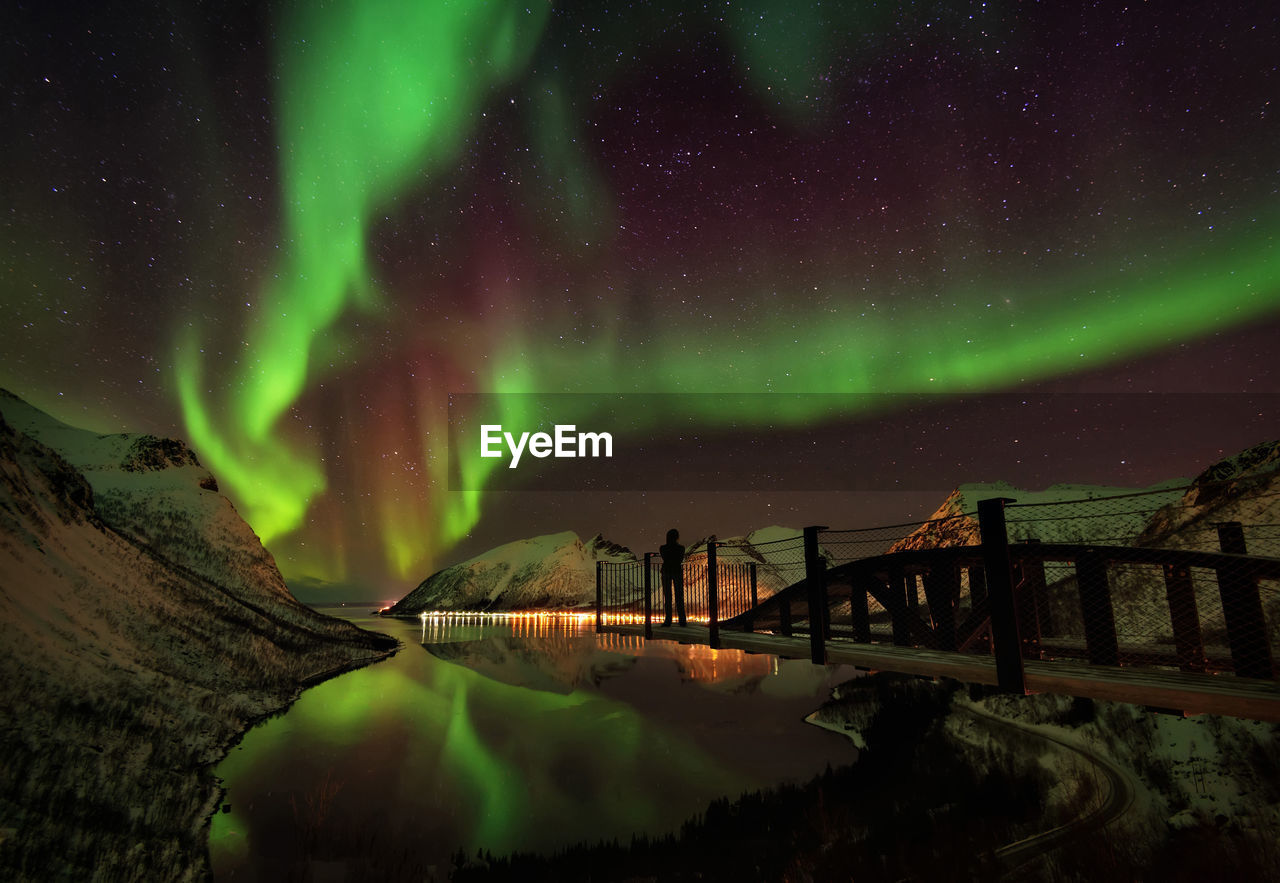 Scenic view of lake against sky at night