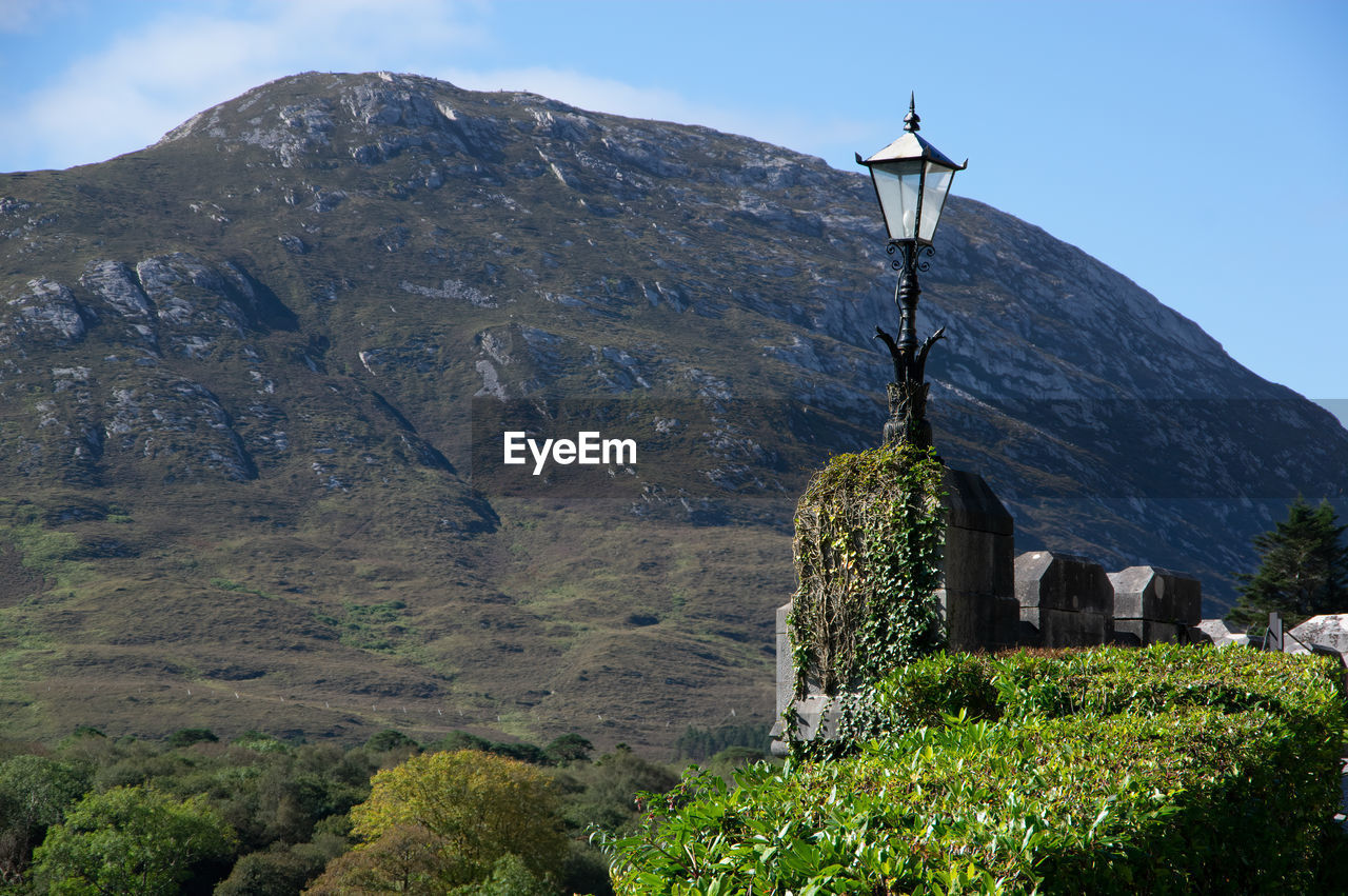 BUILT STRUCTURE ON MOUNTAIN AGAINST SKY