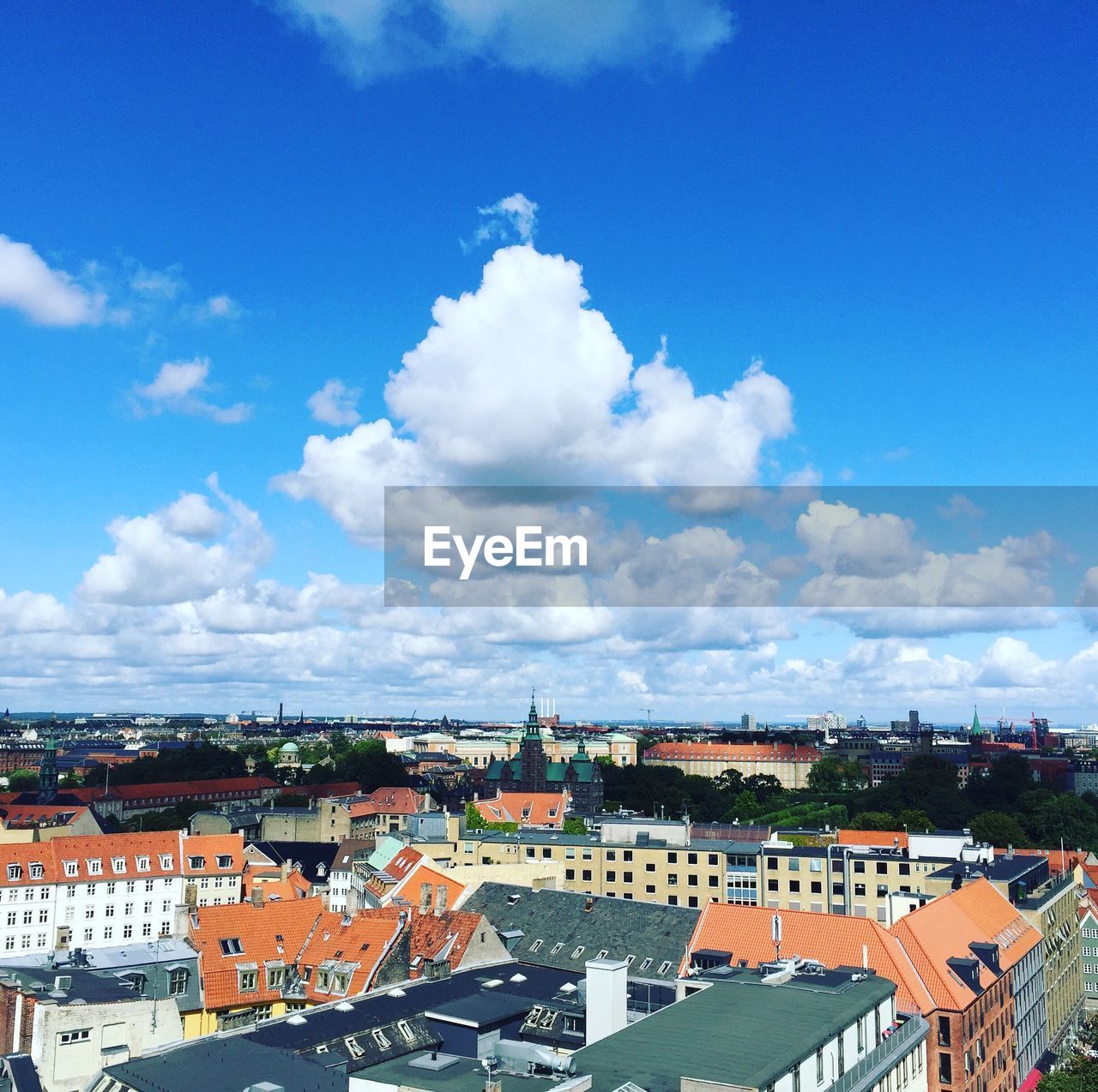 HIGH ANGLE VIEW OF CITY AGAINST BLUE SKY