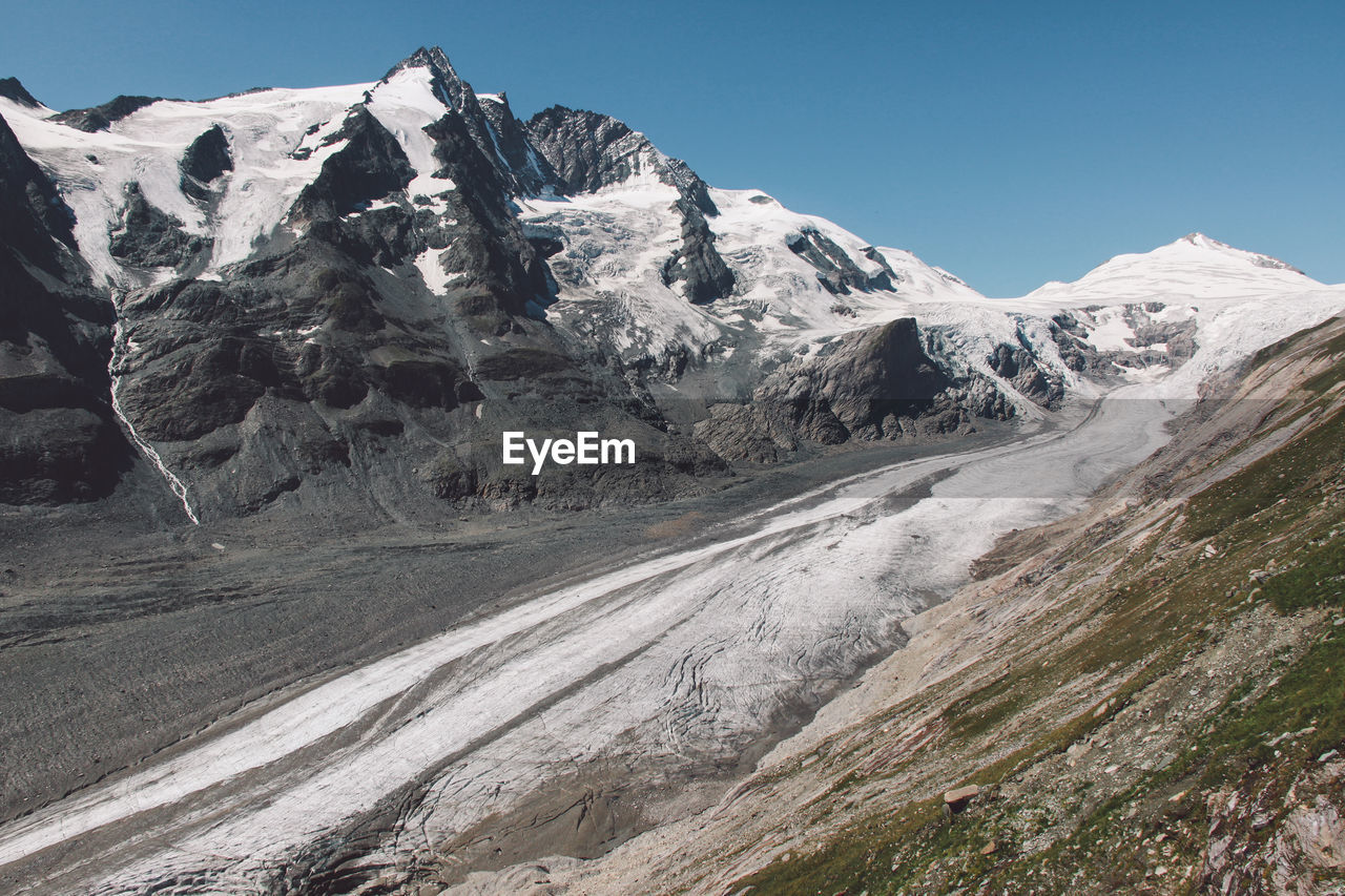 Scenic view of rocky mountains against cloudy sky