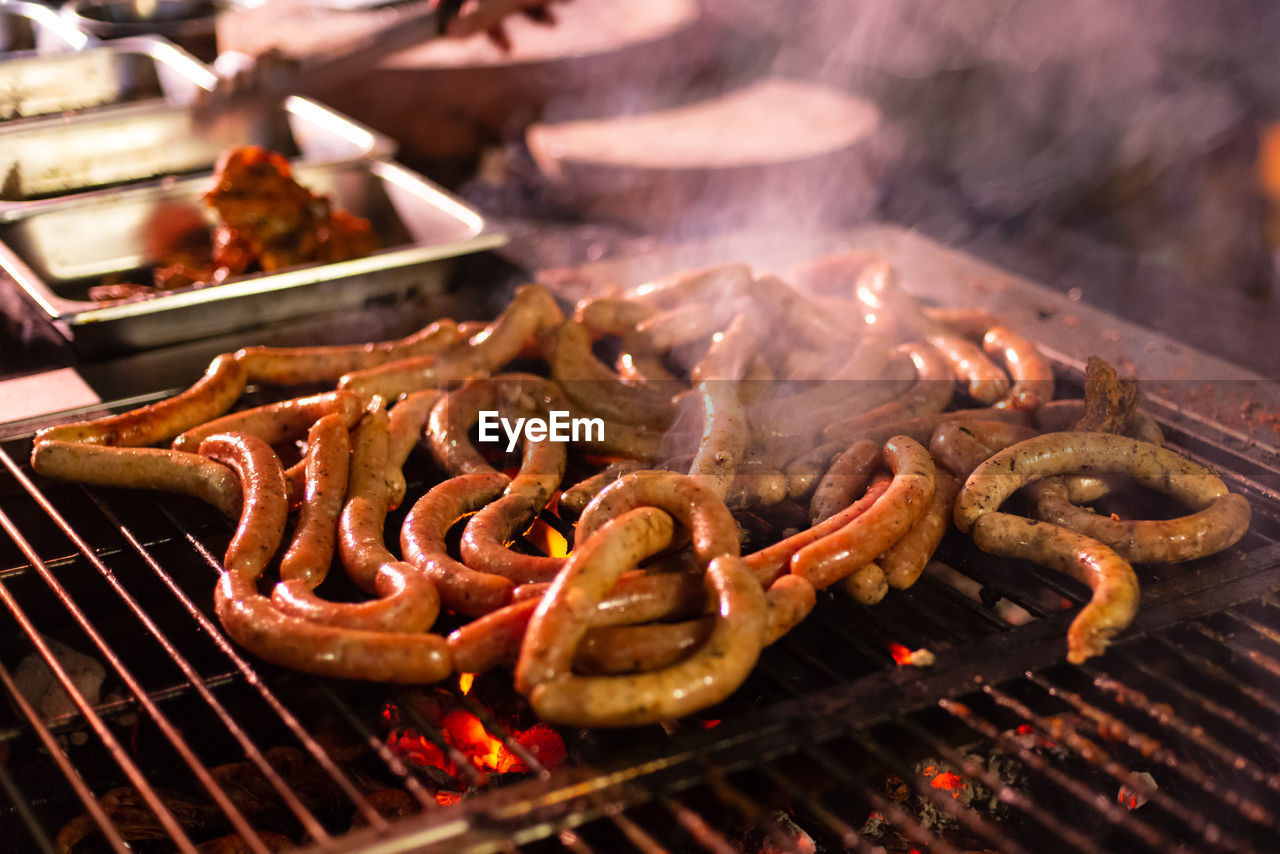 Close-up of meat and sausages on barbecue grill