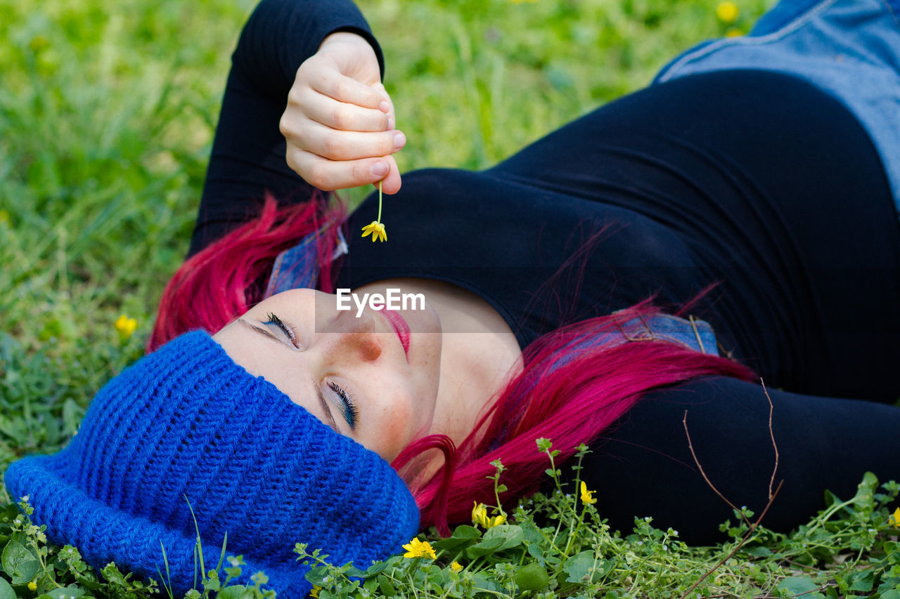 lying down, adult, one person, relaxation, women, nature, plant, grass, blue, person, young adult, clothing, female, lifestyles, portrait photography, leisure activity, portrait, lying on back, smiling, red, eyes closed, outdoors, emotion, field, land, human face, wellbeing, child, happiness, day, photo shoot, green, flower, tranquility, meadow