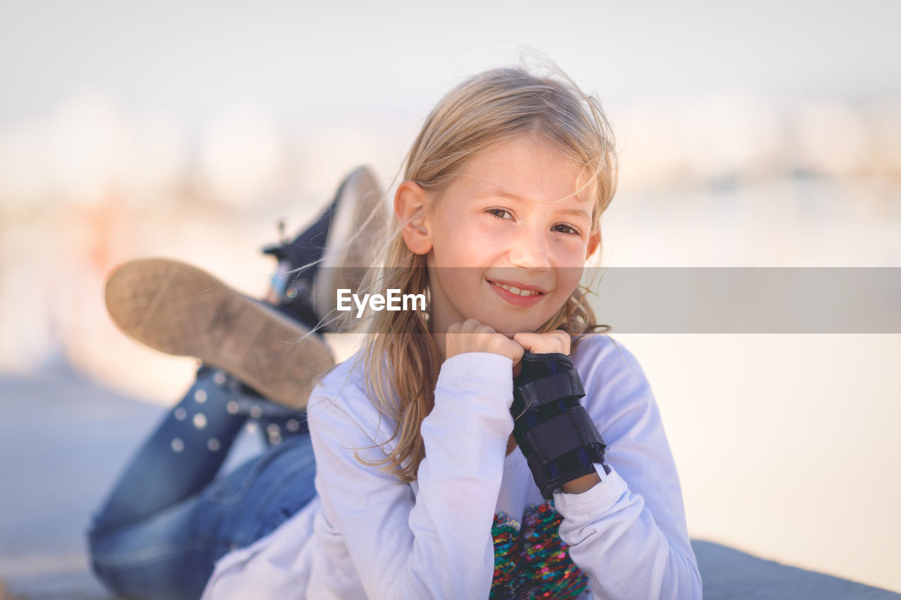 Portrait of smiling girl lying down