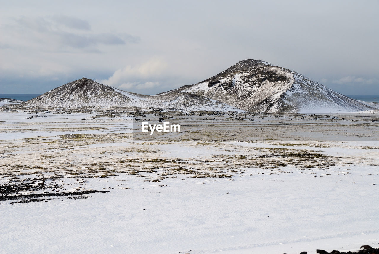 Scenic view of lake against sky during winter